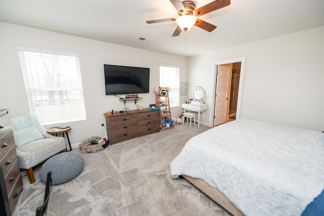 bedroom with carpet flooring, visible vents, baseboards, and a ceiling fan