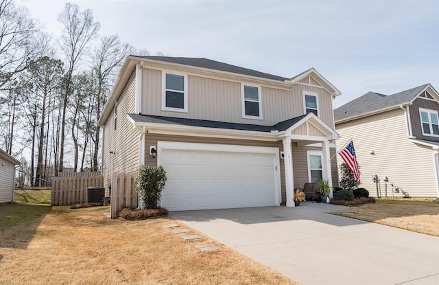 traditional home with board and batten siding, fence, central AC unit, driveway, and an attached garage