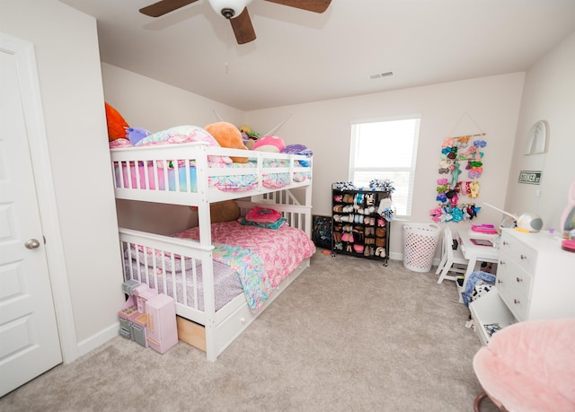 carpeted bedroom with visible vents and a ceiling fan