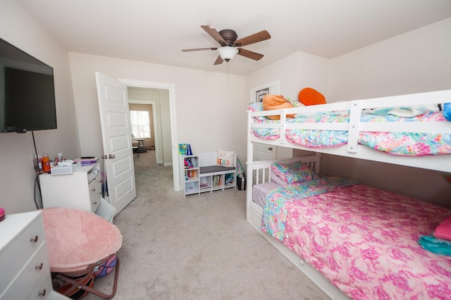 bedroom with a ceiling fan and light carpet