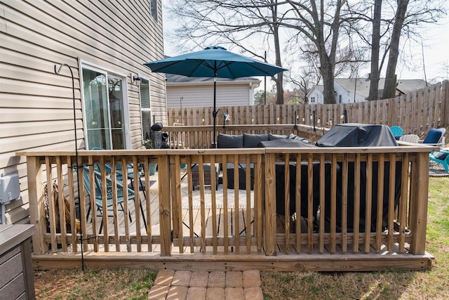 wooden terrace with area for grilling and fence