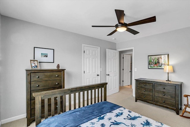 bedroom with carpet flooring, a ceiling fan, and baseboards