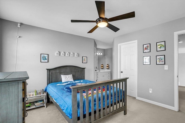 carpeted bedroom featuring connected bathroom, a ceiling fan, and baseboards