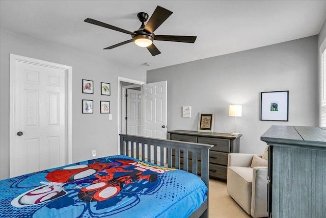 bedroom with a ceiling fan and light carpet