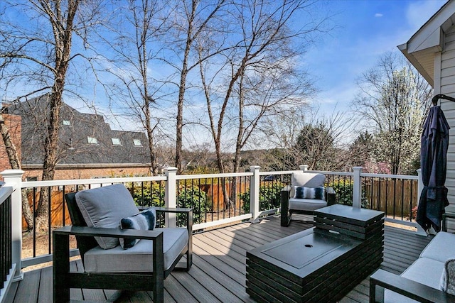 wooden terrace with an outdoor living space