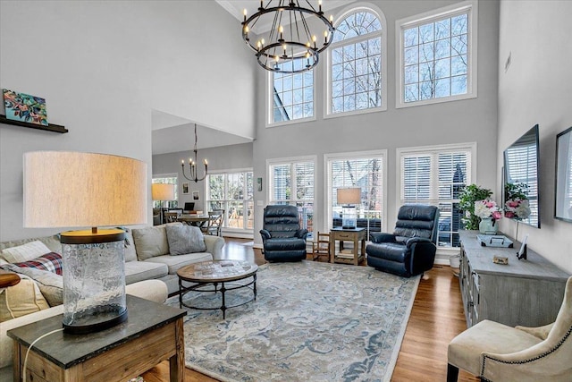 living room featuring an inviting chandelier and wood finished floors