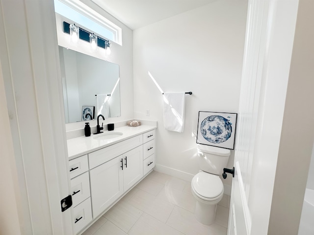 bathroom with tile patterned floors, toilet, vanity, and baseboards