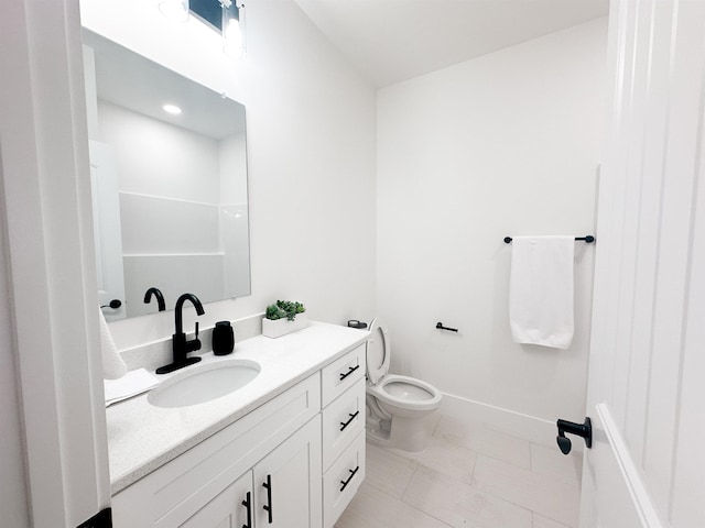 bathroom featuring tile patterned flooring, toilet, vanity, and baseboards