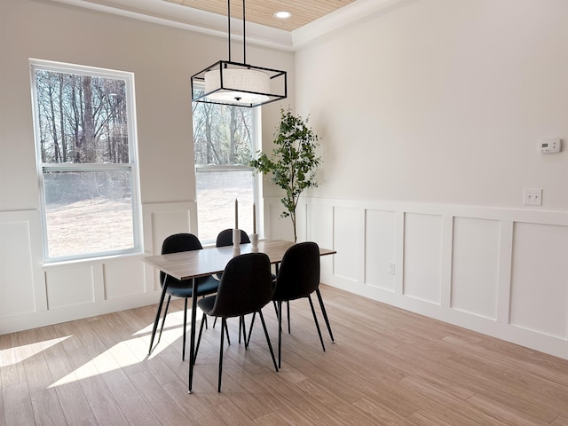 dining room featuring a decorative wall, recessed lighting, and light wood-style floors