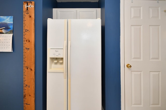 room details featuring white fridge with ice dispenser