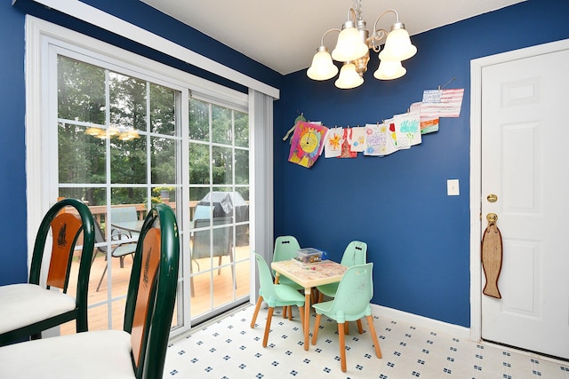 dining area with baseboards and a chandelier