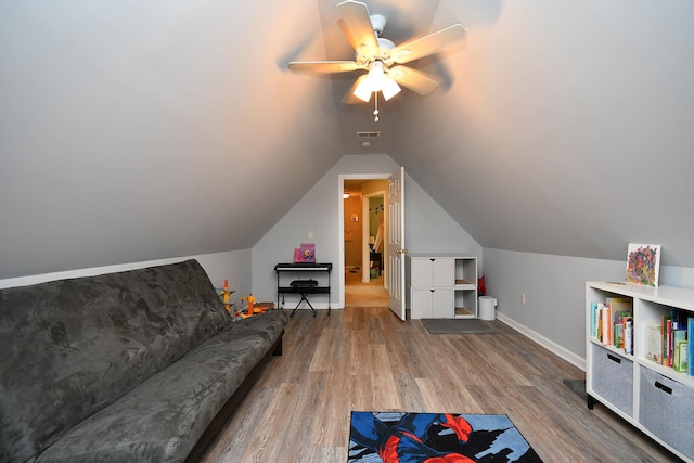 recreation room with visible vents, lofted ceiling, a ceiling fan, wood finished floors, and baseboards