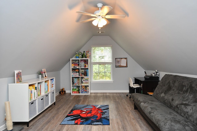 recreation room featuring baseboards, wood finished floors, and vaulted ceiling