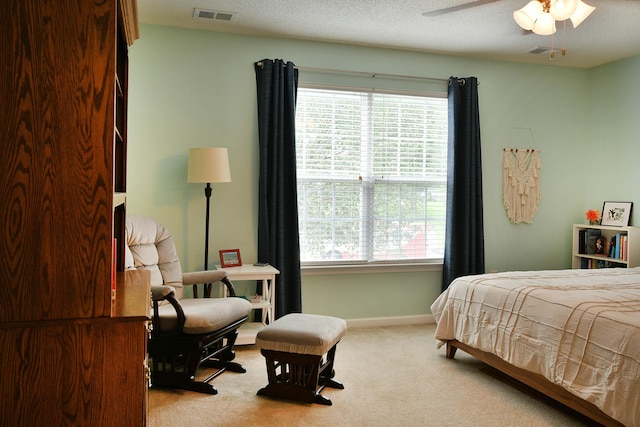 carpeted bedroom featuring visible vents, multiple windows, and baseboards