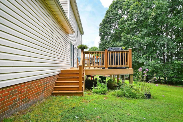 view of side of property featuring a deck, stairs, and a yard