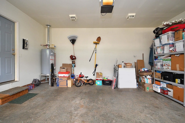 garage featuring a garage door opener and water heater