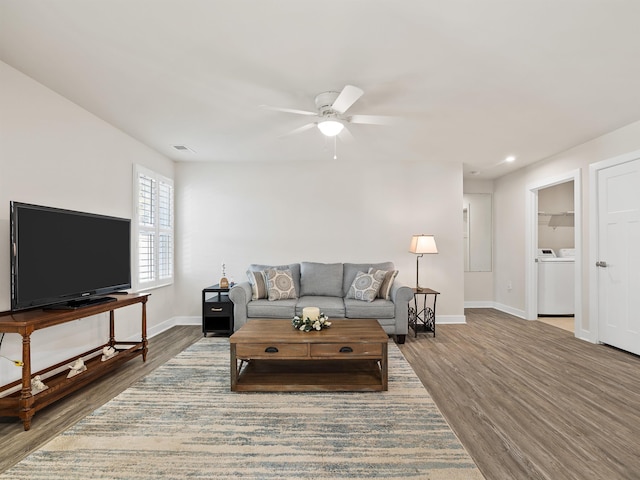 living room with visible vents, baseboards, a ceiling fan, and wood finished floors