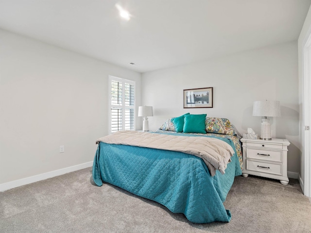 bedroom with visible vents, baseboards, and carpet