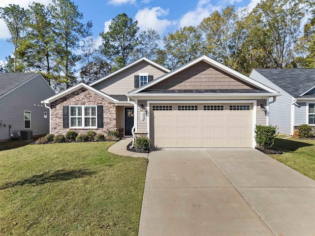 view of front facade with central air condition unit, a front lawn, driveway, stone siding, and a garage