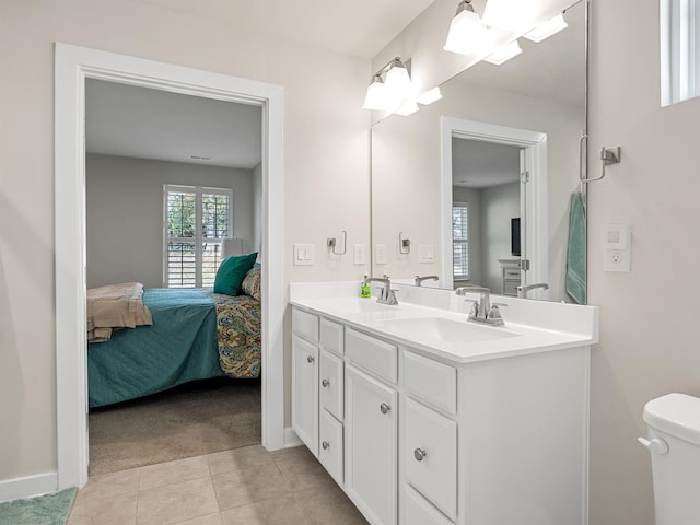 full bath with a sink, ensuite bathroom, toilet, and tile patterned floors