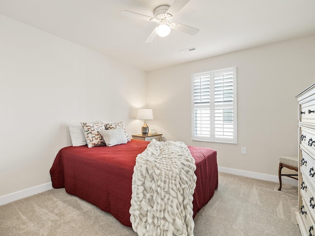 bedroom featuring visible vents, baseboards, and light colored carpet