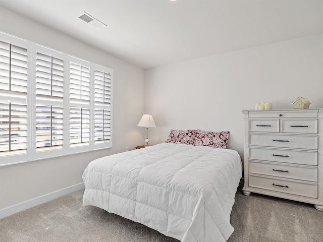 bedroom featuring visible vents, baseboards, and carpet floors