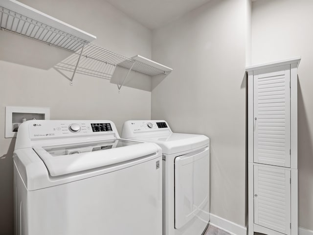 laundry area featuring laundry area, separate washer and dryer, and baseboards