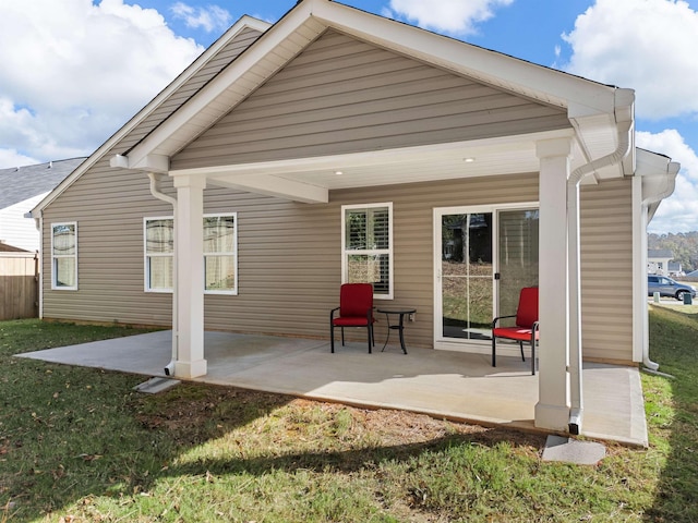 back of house featuring a patio area and a yard