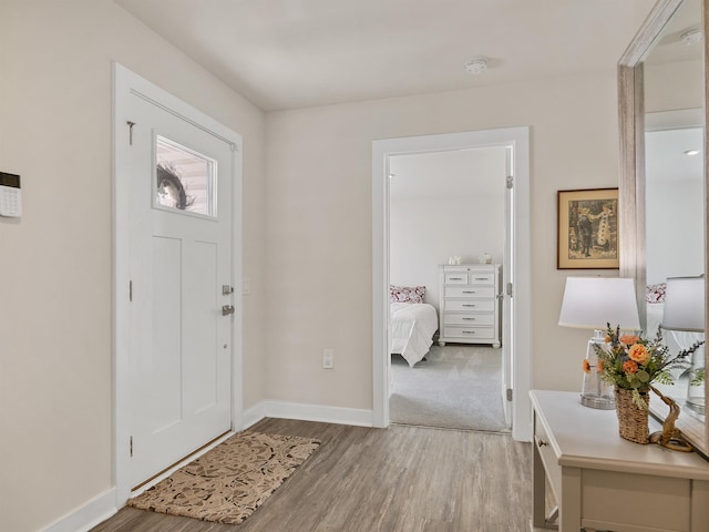 foyer featuring light wood-type flooring and baseboards