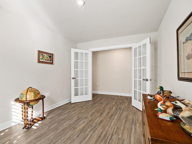 living area with french doors, dark wood-style flooring, and baseboards