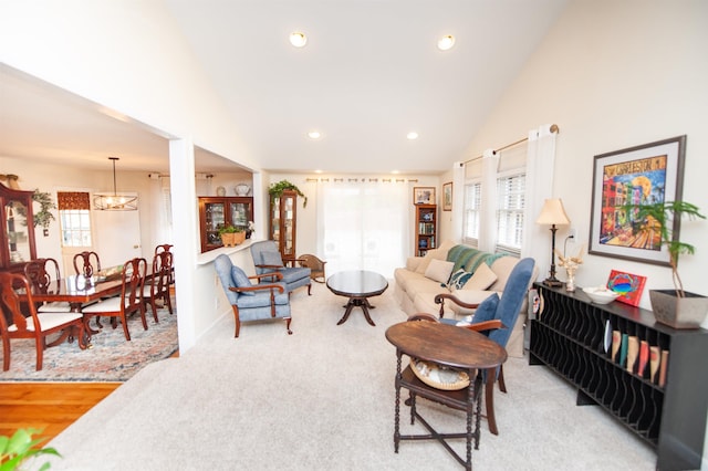 living room featuring a wealth of natural light, lofted ceiling, and recessed lighting