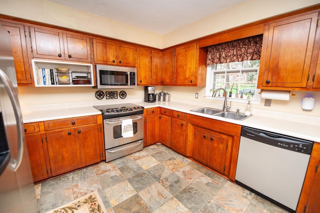 kitchen featuring a sink, appliances with stainless steel finishes, and light countertops