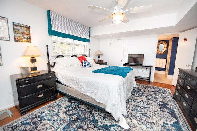 bedroom with wood finished floors, baseboards, and ceiling fan