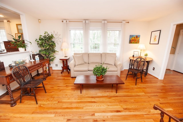 living room featuring light wood-style flooring and baseboards