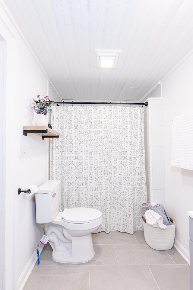 full bathroom featuring a shower with shower curtain, baseboards, toilet, and tile patterned flooring