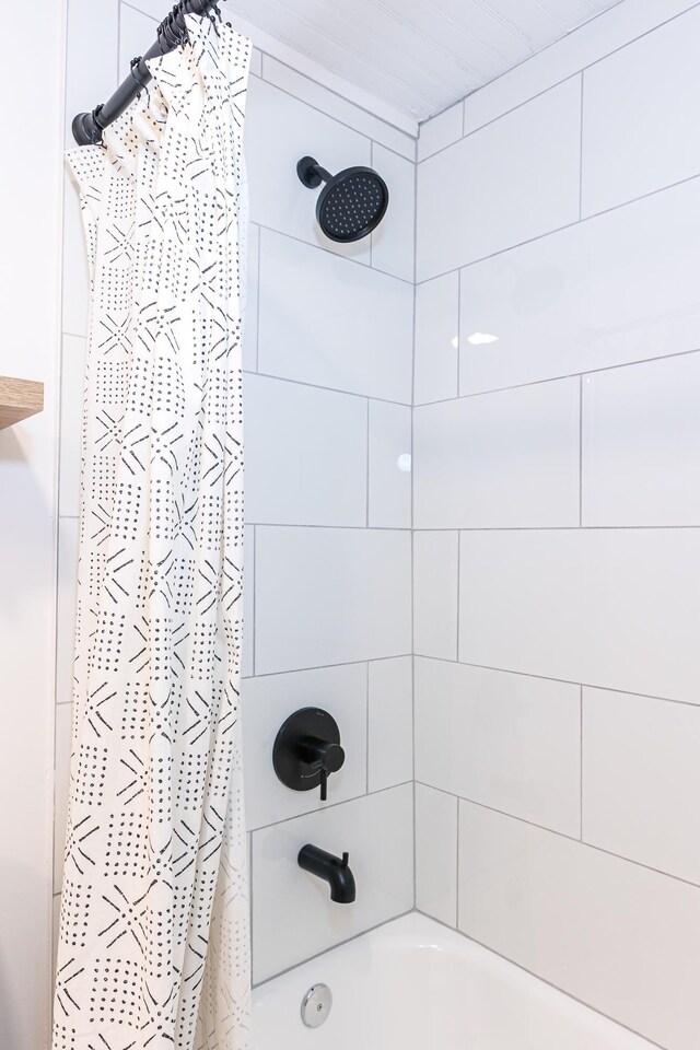 bathroom with shower / bath combo with shower curtain