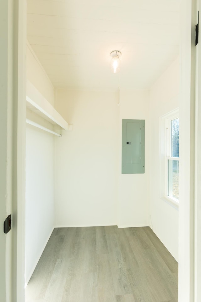 interior space featuring electric panel and wood finished floors