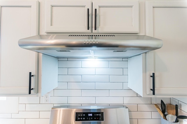 room details with white cabinets, backsplash, and under cabinet range hood