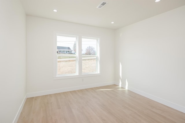 spare room featuring recessed lighting, baseboards, and light wood-style flooring