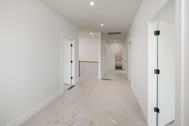 corridor with attic access, recessed lighting, baseboards, and visible vents