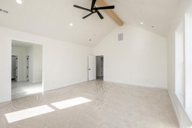 spare room with visible vents, baseboards, ceiling fan, beam ceiling, and high vaulted ceiling