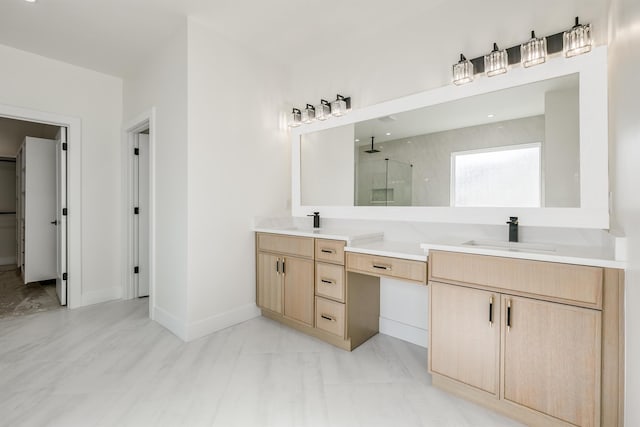 full bath featuring double vanity, a walk in shower, baseboards, and a sink