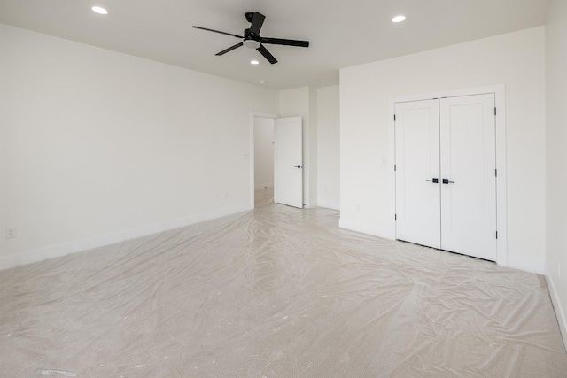 unfurnished bedroom featuring recessed lighting, a closet, baseboards, and ceiling fan