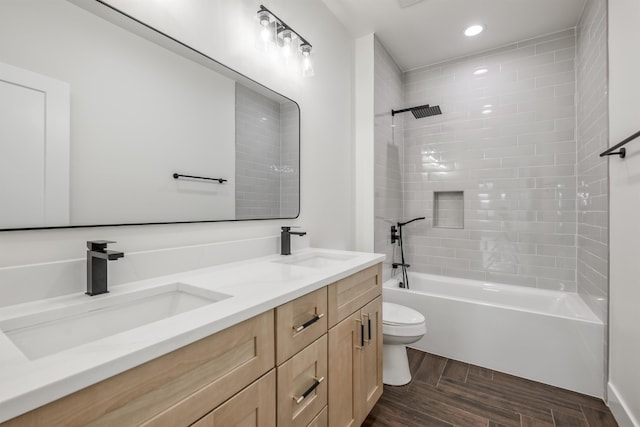 bathroom featuring a sink, toilet, double vanity, and  shower combination