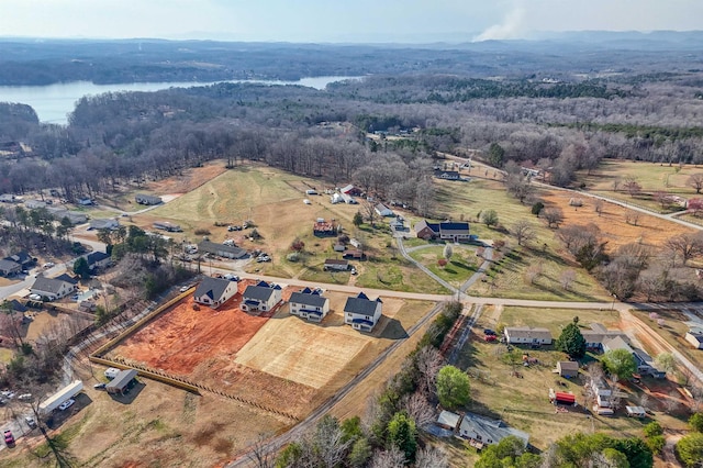 birds eye view of property with a forest view