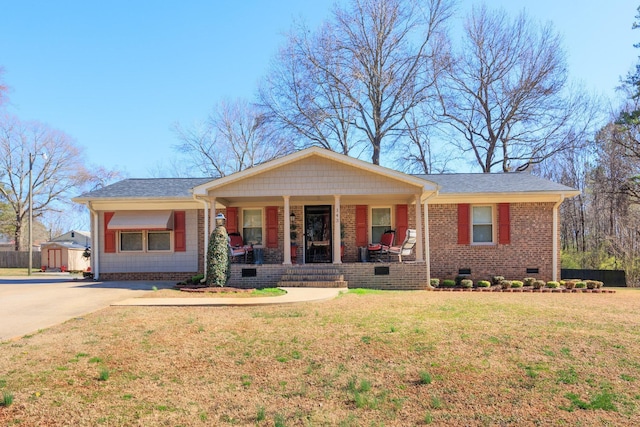 ranch-style home featuring a front lawn, covered porch, concrete driveway, crawl space, and brick siding