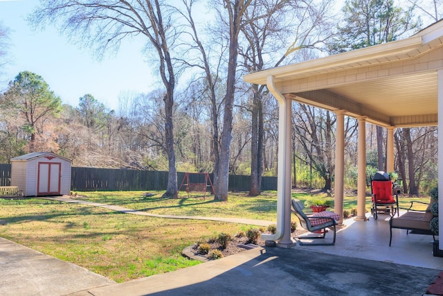 view of yard featuring a patio, an outbuilding, fence private yard, and a shed