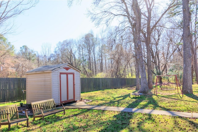 view of yard with a fenced backyard, a storage shed, and an outdoor structure