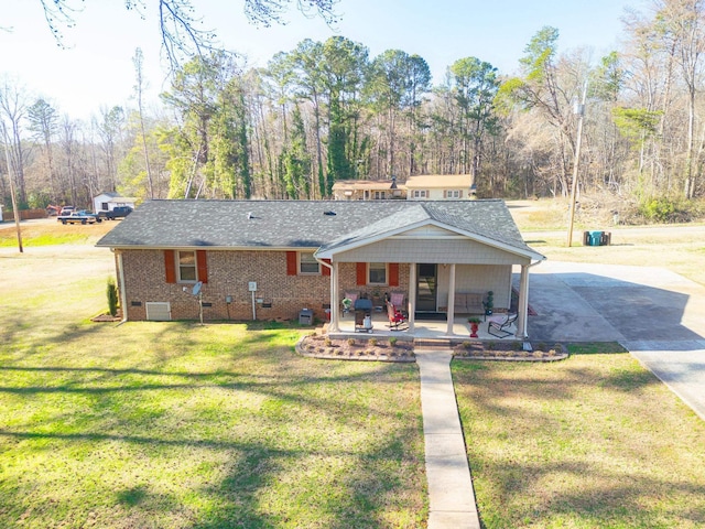 rear view of property with crawl space, driveway, a yard, and roof with shingles