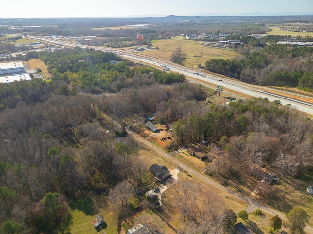 birds eye view of property with a wooded view